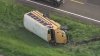 School bus lands on side after crash in Ellis County
