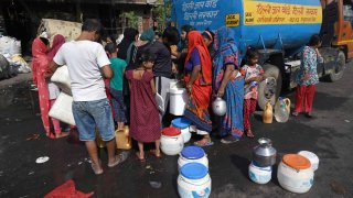 Residents collect water from a tanker during high temperatures in New Delhi, India, on Thursday, May 30, 2024.