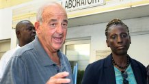 FILE - Pathologist Dr. Cyril Wecht, center, talks to the media while Bahamas' head coroner Linda Virgil, right, and attorney Michael Scott, left, listen outside the Rand Laboratory morgue at the Princess Margaret Hospital in Nassau, Bahamas, Sept. 17, 2006.