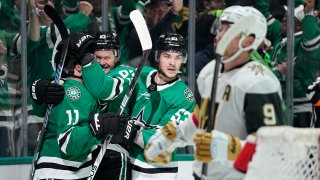 Dallas Stars’ Logan Stankoven (11), Evgenii Dadonov, second from left, and Wyatt Johnston (53) celebrate a goal by Dadonov as Vegas Golden Knights’ Jack Eichel (9) skates past in the first period in Game 5 of an NHL hockey Stanley Cup first-round playoff series in Dallas, Wednesday, May 1, 2024. (AP Photo/Tony Gutierrez)