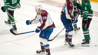 Colorado Avalanche center Nathan MacKinnon (29) celebrates in front of right wing Valeri Nichushkin (13) and Dallas Stars defenseman Miro Heiskanen (4) after scoring a goal in the third period in Game 2 of an NHL hockey Stanley Cup second-round playoff series in Dallas, Tuesday, May 7, 2024. (AP Photo/LM Otero)