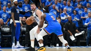 Dallas Mavericks guard Luka Doncic (77) works the floor against Oklahoma City Thunder guard Luguentz Dort (5) during the first half in Game 2 of an NBA basketball second-round playoff series, Thursday, May 9, 2024, in Oklahoma City. (AP Photo/Kyle Phillips)