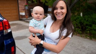 Carrie Martin-Haley holds her son outside their home Friday, May 10, 2024, in Greenwood Village, Colo.