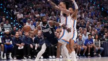 Dallas Mavericks guard Kyrie Irving (11) attempts to make a pass around Oklahoma City Thunder forward Jaylin Williams, right, during the first half in Game 3 of an NBA basketball second-round playoff series, Saturday, May 11, 2024, in Dallas. (AP Photo/Tony Gutierrez)