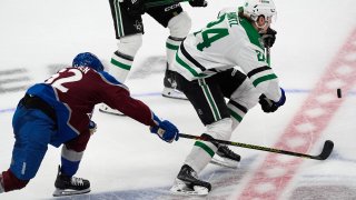 Dallas Stars center Roope Hintz, right, pursues the puck as Colorado Avalanche left wing Artturi Lehkonen defends during the third period of Game 3 of an NHL hockey Stanley Cup playoff series Saturday, May 11, 2024, in Denver.
