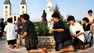 Bosnian Roman Catholic women pray on the occasion of the feast of the Assumption in Medjugorje, some 120 kilometers (75 miles) south of the Bosnian capital Sarajevo on Tuesday.