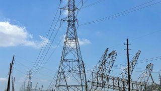 Power transmission lines were twisted and toppled after powerful storms swept through the Houston area on Saturday, May 18, 2024 in Cypress, Texas. As the Houston area works to clean up and restore power to hundreds of thousands, it will do so amid a smog warning and rising Texas heat. (AP photo/Mark Vancleave)