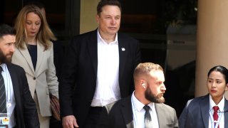 Elon Musk, center, arrives for the 10th World Water Forum in Nusa Dua, Bali, Indonesia on Monday, May 20, 2024. A group of Tesla shareholders are asking investors to vote against a compensation package worth more than $40 billion for CEO Elon Musk, saying that it’s not in the electric vehicle maker’s best interest.(AP Photo/Firdia Lisnawati, File)