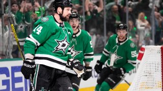 Dallas Stars left wing Jamie Benn (14), Wyatt Johnston, center, and Thomas Harley, right, celebrate after Benn scored during the first period in Game 2 of the Western Conference finals in the NHL hockey Stanley Cup playoffs against the Edmonton Oilers, Saturday, May 25, 2024, in Dallas. (AP Photo/Tony Gutierrez)
