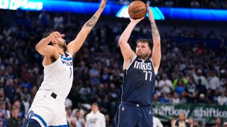 Dallas Mavericks guard Luka Doncic (77) shoots against Minnesota Timberwolves forward Kyle Anderson (1) during the second half in Game 3 of the NBA basketball Western Conference finals, Sunday, May 26, 2024, in Dallas. (AP Photo/Julio Cortez)