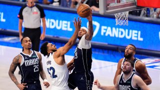 Minnesota Timberwolves center Karl-Anthony Towns (32) is blocked by Dallas Mavericks center Daniel Gafford (21) as he tries to score during the second half in Game 4 of the NBA basketball Western Conference finals, Tuesday, May 28, 2024, in Dallas. (AP Photo/Julio Cortez)