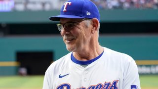 ARLINGTON, TEXAS – APRIL 23: Mitch Garver #18 of the Seattle Mariners stands with manager Bruce Bochy #15 of the Texas Rangers before the game at Globe Life Field on April 23, 2024 in Arlington, Texas. Garver was presented with his 2023 World Series ring before the game.