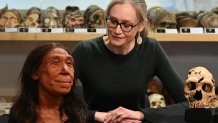 Associate Professor in the Evolution of Health, Diet and Disease, Dr Emma Pomeroy, poses for a photograph with the rebuilt skull and a physical reconstruction of the face and head, of a 75,000-year-old Neanderthal woman, named Shanidar Z, at the University of Cambridge, eastern England, on April 25, 2024. A UK team of archaeologists on Thursday revealed the reconstructed face of a 75,000-year-old Neanderthal woman as researchers reappraise the perception of the species as brutish and unsophisticated. Emma Pomeroy, the Cambridge palaeo-anthropologist who uncovered Shanidar Z, said finding her skull and upper body had been both "exciting" and "terrifying". Named Shanidar Z after the cave in Iraqi Kurdistan where her skull was found in 2018, the latest discovery has led experts to probe the mystery of the forty-something Neanderthal woman laid to rest in a sleeping position beneath a huge vertical stone marker. (Photo by Justin TALLIS / AFP) / TO GO WITH AFP STORY by Helen ROWE (Photo by JUSTIN TALLIS/AFP via Getty Images)