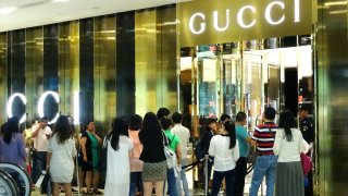 Customers wait outside Gucci Store in Xinjiekou business center on May 29, 2015 in Nanjing, Jiangsu province of China.