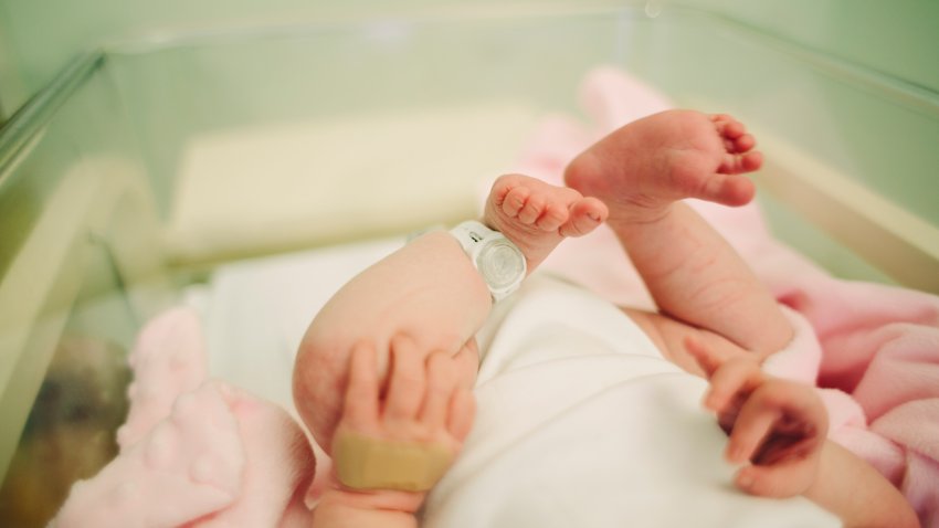 View of baby’s feet with a hospital security tag on