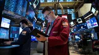 Traders work on the floor of the New York Stock Exchange during morning trading on Jan. 3, 2024, in New York City.