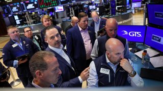 Traders and floor officials react to technical issues on the floor at the New York Stock Exchange on June 3, 2024.