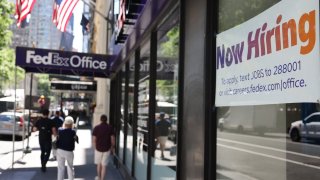 A “Now Hiring” sign is seen at a FedEx location in New York City, June 7, 2024.