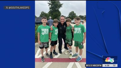 School resource officer poses with students in Southlake ISD