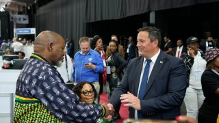 Leader of the main opposition Democratic Alliance John Steenhuisen, right, shakes hands with ANC's Chairman. Gwede Mantashe, left, on a visit to the Results Operation Centre (ROC) in Midrand, Johannesburg, South Africa, Friday May 31, 2024. South Africa is heading closer to the reality of a national coalition government for the first time as partial election results put the ruling African Nation Congress (ANC), short of a majority.