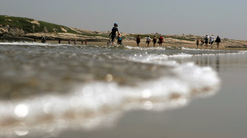 FILE – Beachgoers enjoy the walk at low tide out to Fox Island off of Popham Beach State Park in Phippsburg, Maine, June 26, 2007. Jamie Acord, from Maine, learned the hard way over the weekend that quicksand doesn’t just happen in jungles or rainforests in Hollywood movies — she was walking at the water’s edge at Popham Beach State Park when she sunk to her hips in a split second.