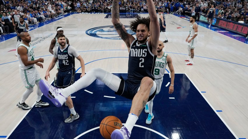 Dallas Mavericks center Dereck Lively II (2) scores against the Boston Celtics during Game 4 of the NBA basketball finals, Friday, June 14, 2024, in Dallas. (Stacy Revere/Pool Photo via AP)