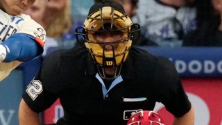 Los Angeles Dodgers’ Shohei Ohtani, left, hits a two-run home run as Los Angeles Angels catcher Logan O’Hoppe, right, watches along with home plate umpire James Hoye during the third inning of a baseball game Saturday, June 22, 2024, in Los Angeles.