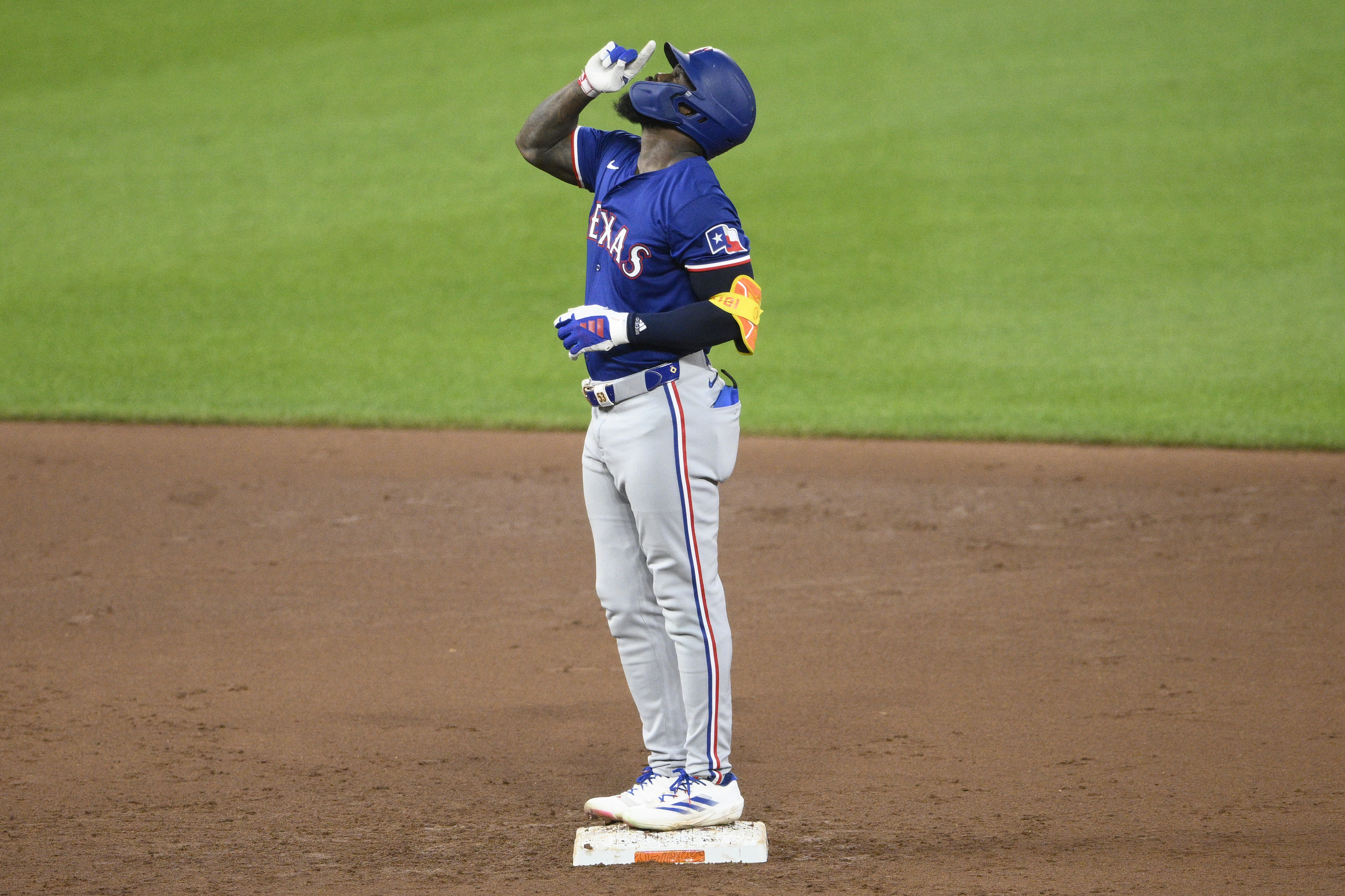 Texas Rangers’ Adolis García gestures at second base after he doubled during the fifth inning of a baseball game against the Baltimore Orioles, Sunday, June 30, 2024, in Baltimore. (AP Photo/Nick Wass)