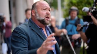 Right-wing conspiracy theorist Alex Jones speaks to the media after arriving at the federal courthouse for a hearing in front of a bankruptcy judge Friday, June 14, 2024, in Houston. The judge is expected to rule on whether to liquidate Jones’ assets to help pay the $1.5 billion he owes for his false claims that the Sandy Hook Elementary School shooting was a hoax. (AP Photo/David J. Phillip)