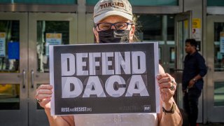 Participant seen holding a DACA sign at the protest.