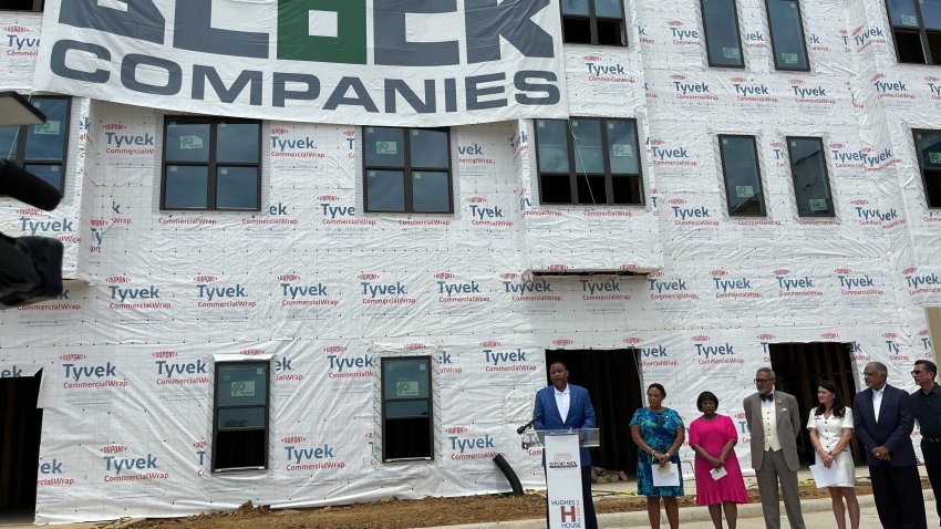 Check presented to Hughes House II housing project in Fort Worth's Stop Six neighborhood. (NBC 5 photo/Tahera Rahman)