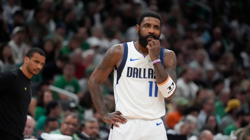 Dallas Mavericks guard Kyrie Irving pauses on the court in front of Boston Celtics head coach Joe Mazzulla, left, during the first half of Game 5 of the NBA basketball finals, Monday, June 17, 2024, in Boston. (AP Photo/Charles Krupa)