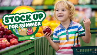 Young boy picking fruit during the Wilkinson Center Stock Up For Summer