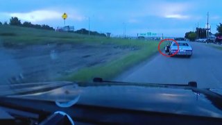 Dashcam video from a Cedar Hill police car shows a driver open his door and lean out and fire a weapon, the flash can be seen cirlced in red.