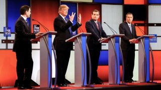 Then-Republican presidential candidate Donald Trump, second from left, gestures as Sen. Marco Rubio, R-Fla., Sen. Ted Cruz, R-Texas, and Ohio Gov. John Kasich watch him, during a Republican presidential primary debate at Fox Theatre on March 3, 2016, in Detroit.