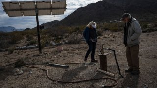 Georganne Bradbury, left, and Rick Bradbury inspect their water well as they give a tour of their water system at their home on Terlingua Ranch in South Brewster County. The couple has garnered a reputation among locals for their services as the area’s trusted water haulers, often delivering between three and four 500-gallon truckloads of water a day during peak tourism season.
