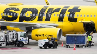 Ground crews work to prepare a Spirit Airlines plane at George Bush Intercontinental Airport, Tuesday, Nov. 21, 2023, in Houston.