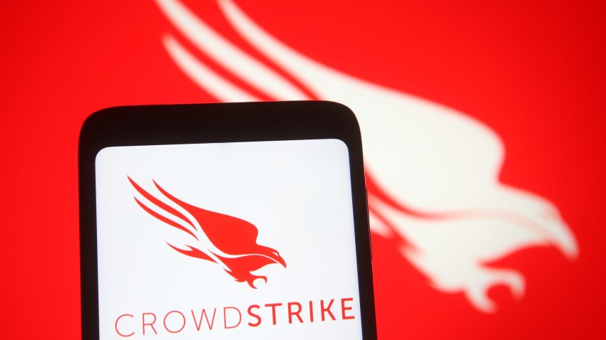 In this photo illustration, CrowdStrike logo of a U.S. cybersecurity technology company is seen on a smartphone and a pc screen.