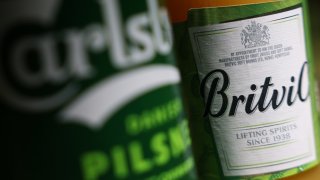 A can of Carlsberg AS pilsner and a Britvic Plc apple drink arranged in London, UK, on Friday, June 21, 2024. 