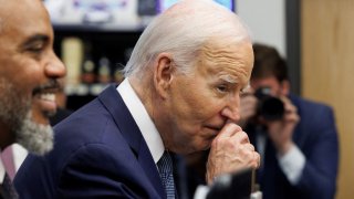 U.S. President Joe Biden rubs his nose while greeting shoppers inside Mario’s Westside Market grocery store in Las Vegas, Nevada, U.S., July 16, 2024. 