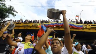 A man bangs a cooking pot during a protest against Venezuelan President Nicolas Maduro’s government in Valencia, Carabobo state, Venezuela on July 29, 2024, a day after the Venezuelan presidential election.