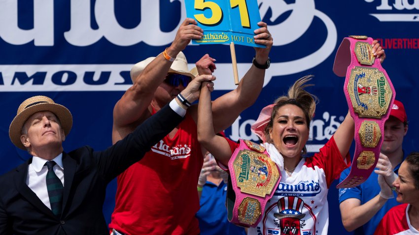 Miki Sudo, right, reacts after winning the women’s division in the Nathan’s Famous Fourth of July hot dog eating contest, Thursday, July 4, 2024, at Coney Island in the Brooklyn borough of New York. Sudo ate a record 51 hot dogs.