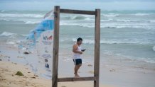 A man walks on the beach in the aftermath of Hurricane Beryl in Tulum, Mexico, Friday, July 5, 2024. (AP Photo/Fernando Llano)