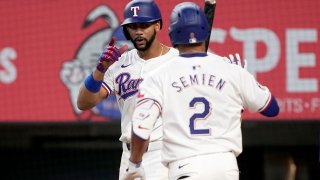 Texas Rangers’ Leody Taveras, left, and Marcus Semien (2) celebrate after Semien hit a two-run home run that also scored Taveras against the Tampa Bay Rays in the seventh inning of a baseball game in Arlington, Texas, Saturday, July 6, 2024. (AP Photo/Tony Gutierrez)