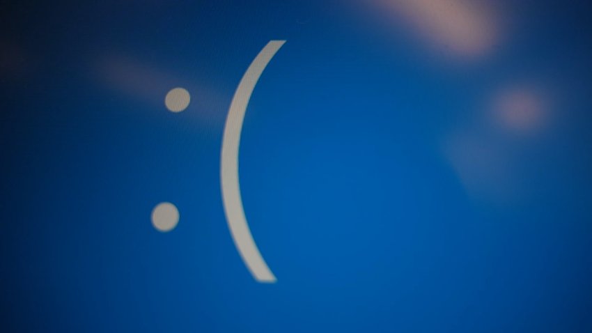 A sad face smiley on a blue computer screen