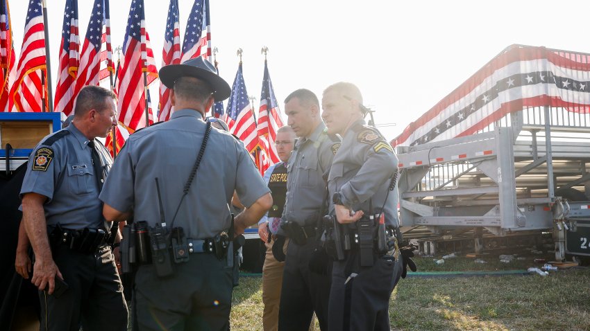 Law enforcement agents stand near the stage