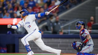 TORONTO, CANADA – JULY 26: Justin Turner #2 of the Toronto Blue Jays hits a double in the seventh inning of their MLB game against the Texas Rangers at Rogers Centre on July 26, 2024 in Toronto, Ontario, Canada.