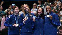 Silver medallists US' Kate Douglass, US' Gretchen Walsh, US' Torri Huske and US' Simone Manuel pose with their medals on the podium of the women's 4x100m freestyle relay