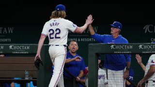 ARLINGTON, TEXAS – JULY 23: Jon Gray #22 of the Texas Rangers is greeted by pitching coach Mike Maddux #41 as he walks to his dugout after being removed from the game during the eighth inning against the Chicago White Sox at Globe Life Field on July 23, 2024 in Arlington, Texas.