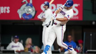 ARLINGTON, TEXAS – JULY 24: Nathaniel Lowe #30 of the Texas Rangers hits a three-run home run during the eighth inning against the Chicago White Sox at Globe Life Field on July 24, 2024 in Arlington, Texas.